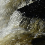 Photo of water rushing over Shohola Falls waterfall in Pike County, PA.